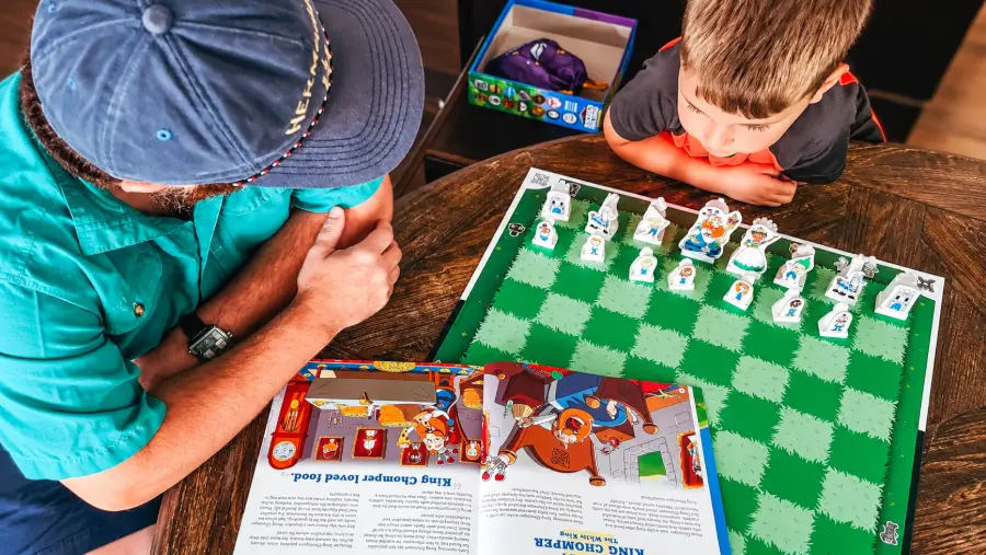 Adult and child playing Story Time Chess